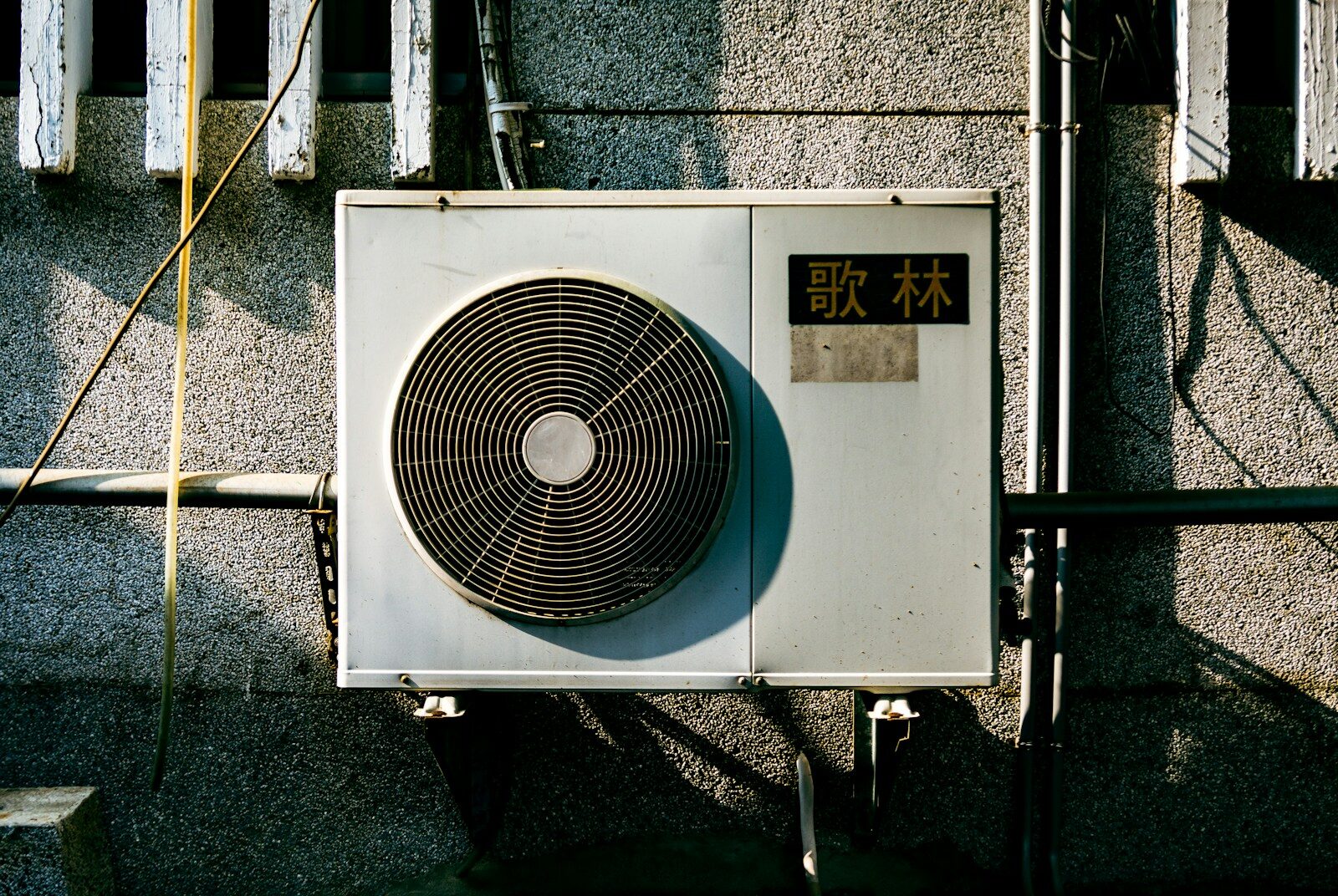 a wall mounted air conditioner mounted on the side of a building